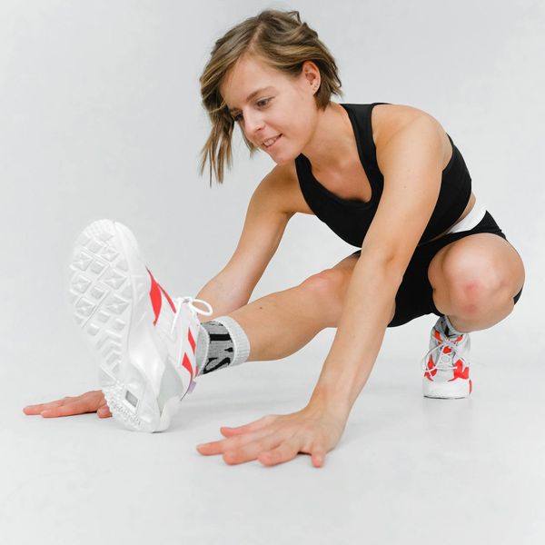 Woman performing an advanced yoga pose demonstrating strength and flexibility.
